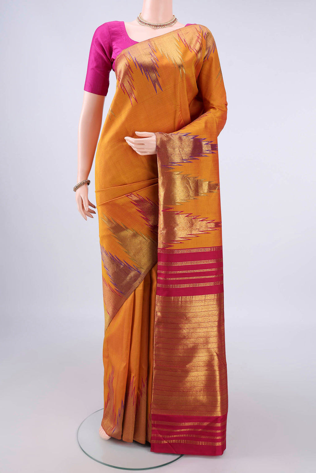 Pure Silk Mustard Kanjivaram Saree with Plain Body and Temple Border.  displayed on a mannequin