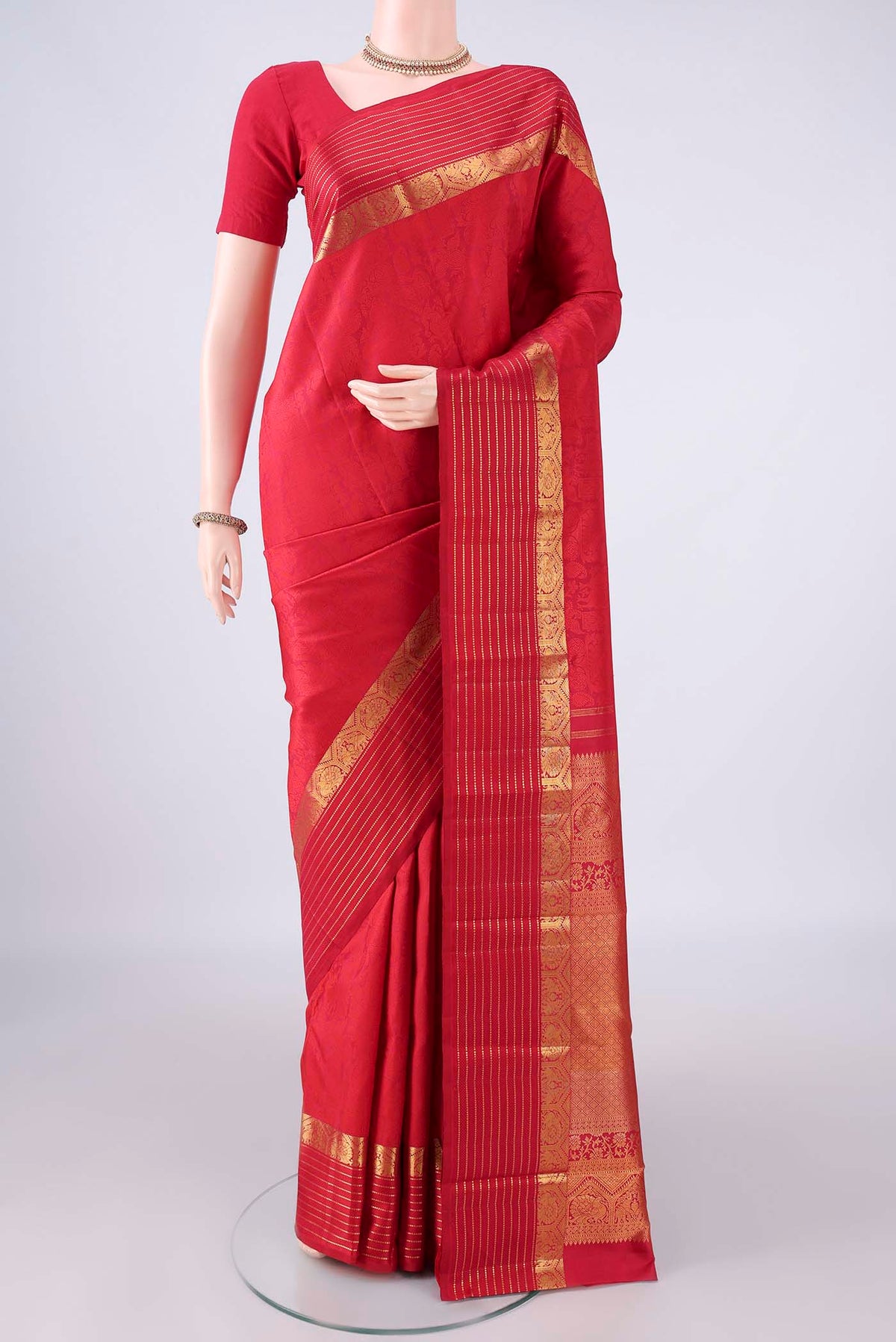 Pure Silk Deep Red Kanjivaram Saree with Jacquard design on the body and Zari Border.  displayed on a mannequin