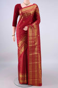 Pure Silk Maroon Kanchipuram Saree with Zari Butta on the body and Zari Border.  displayed on a mannequin