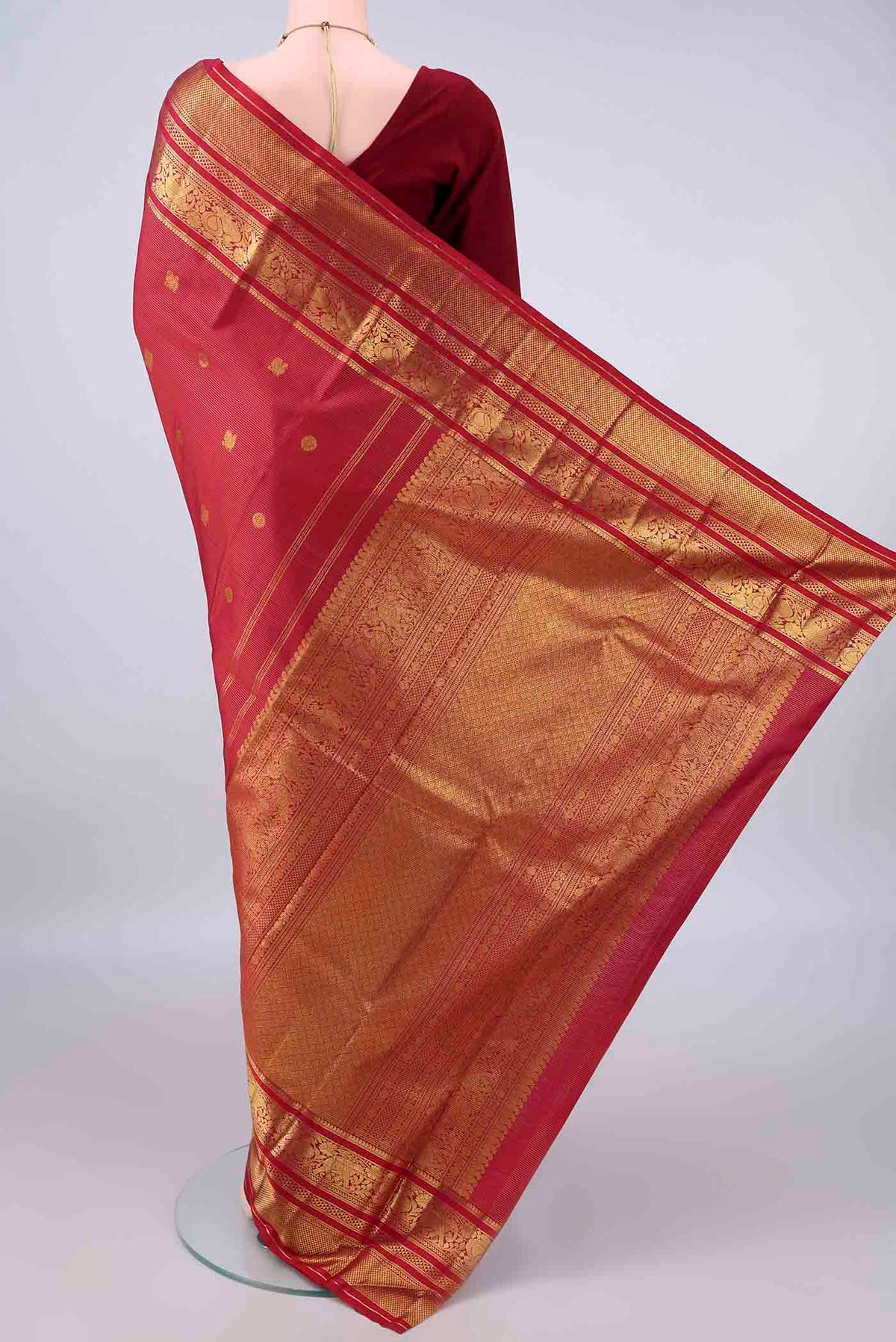 Flat view of Pure Silk Maroon Kanchipuram Saree with Zari Butta on the body and Zari Border. 