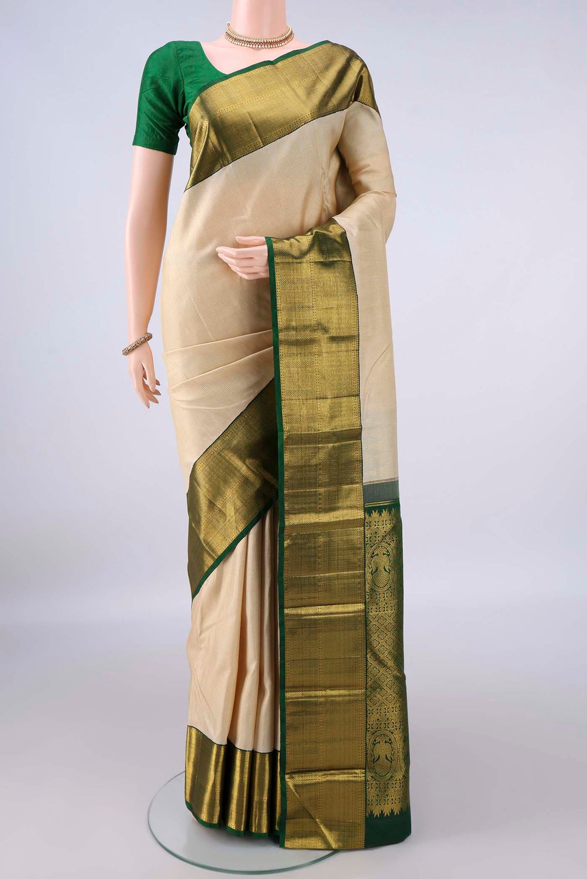 Pure Silk Cream Kanchipuram Saree with Checked design on the body and Zari Border.  displayed on a mannequin