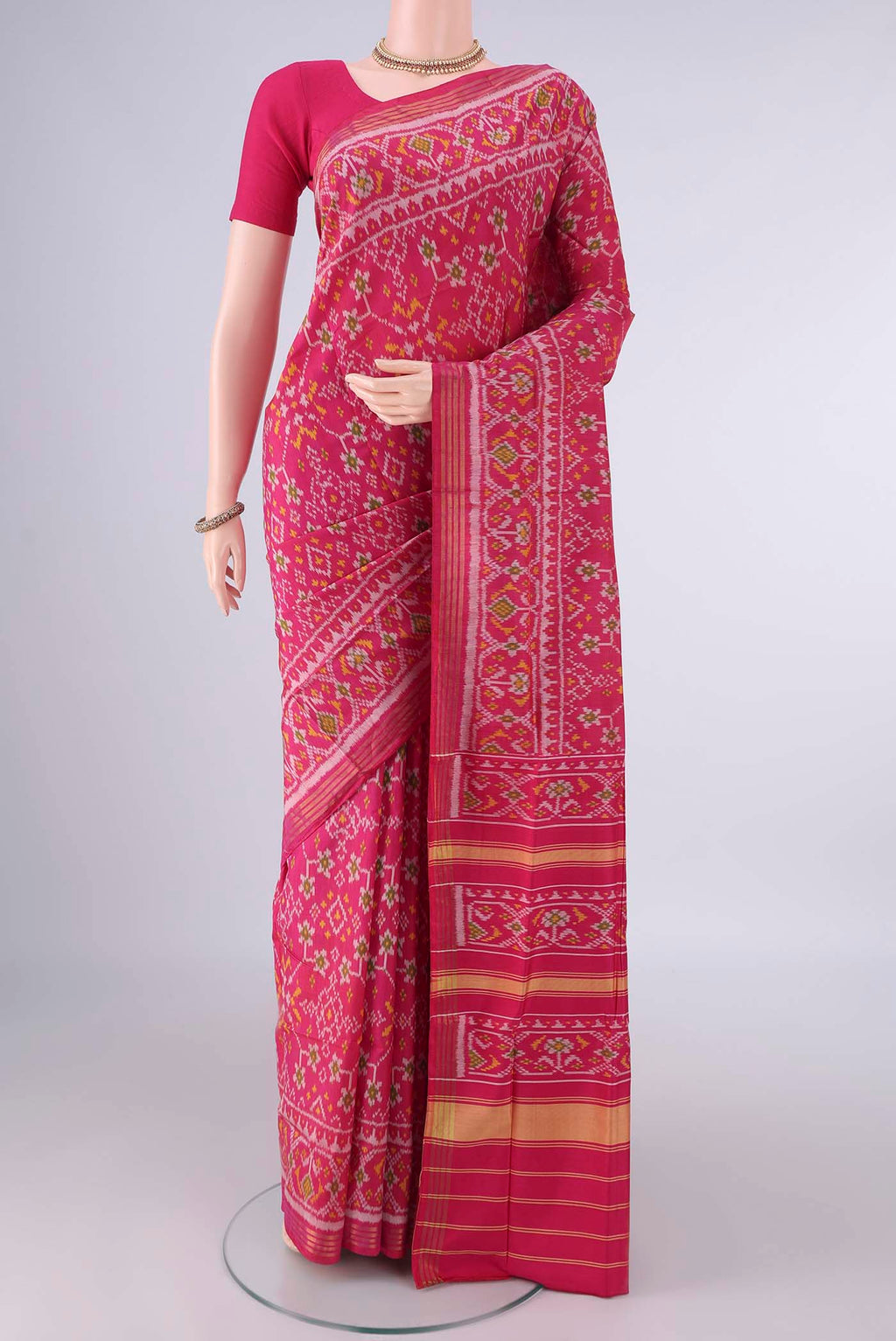Pure Silk Rani Pink Rajkot Patola Saree with Pure Ikat on the body and Ikat Border.  displayed on a mannequin