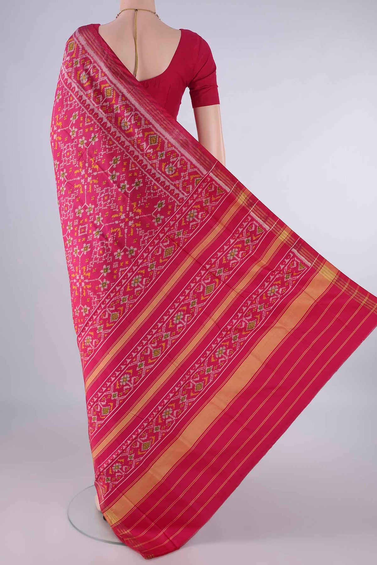 Flat view of Pure Silk Rani Pink Rajkot Patola Saree with Pure Ikat on the body and Ikat Border. 