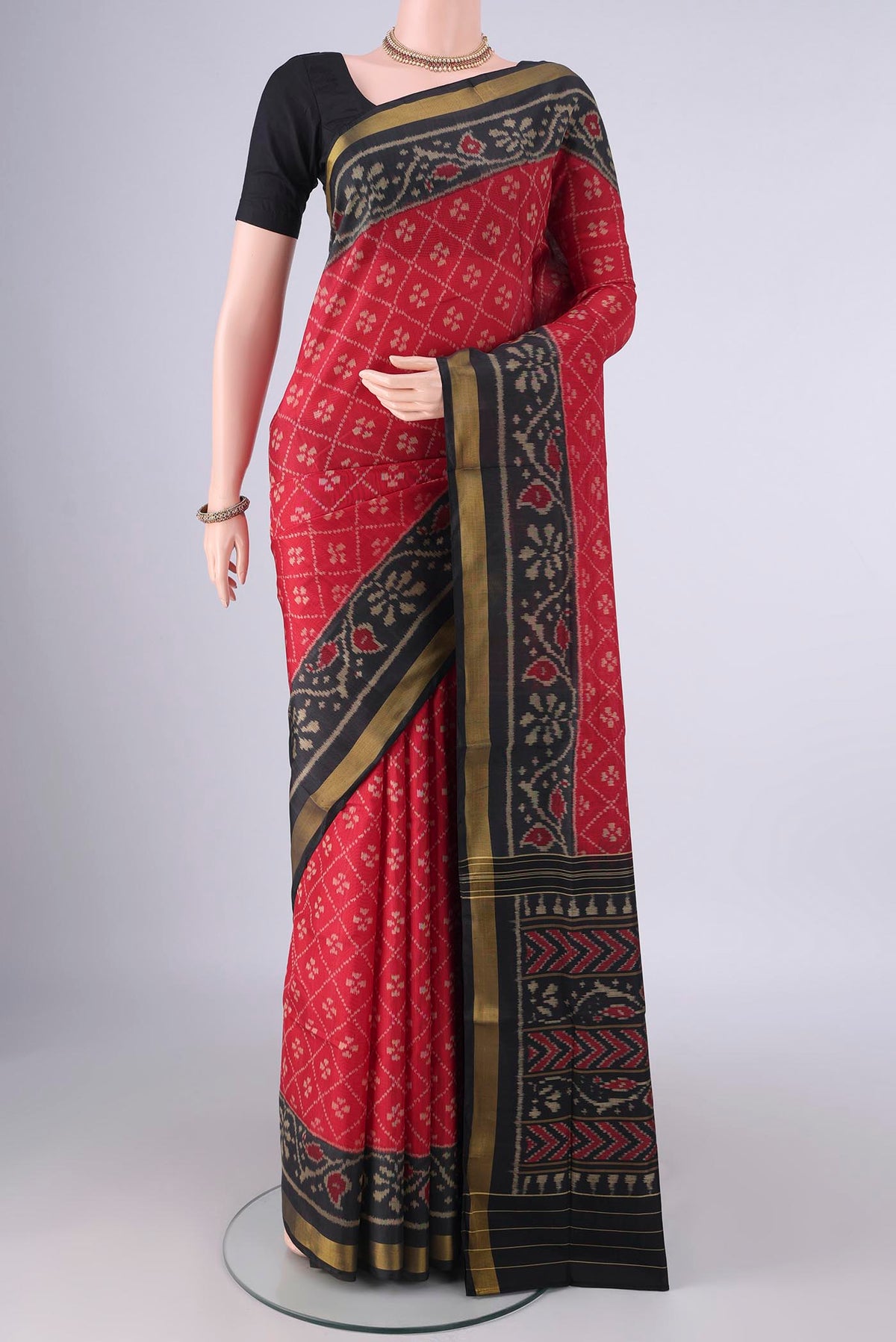 Pure Silk Red Rajkot Patola Saree with Pure Ikat on the body and Ikat Border.  displayed on a mannequin