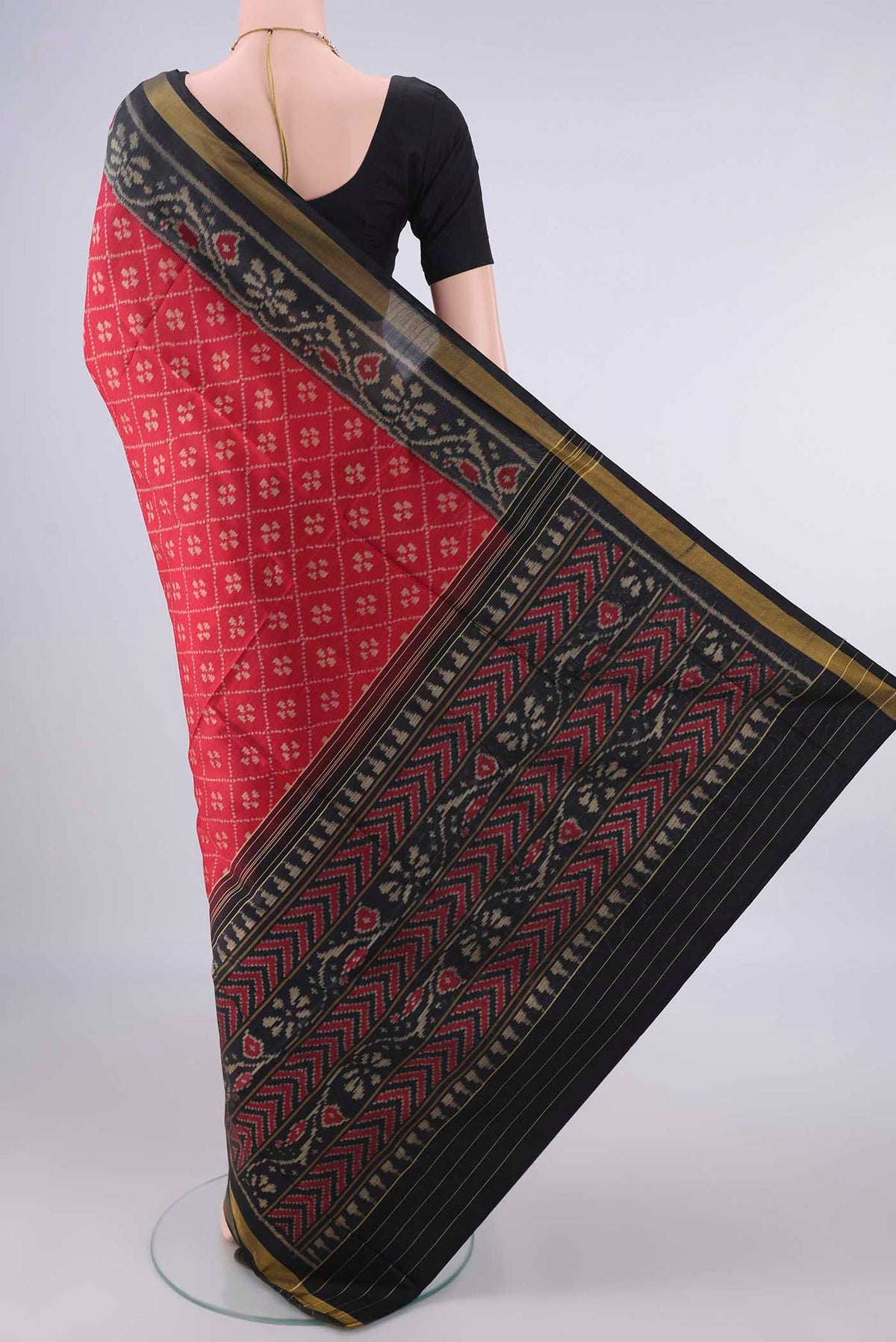 Flat view of Pure Silk Red Rajkot Patola Saree with Pure Ikat on the body and Ikat Border. 