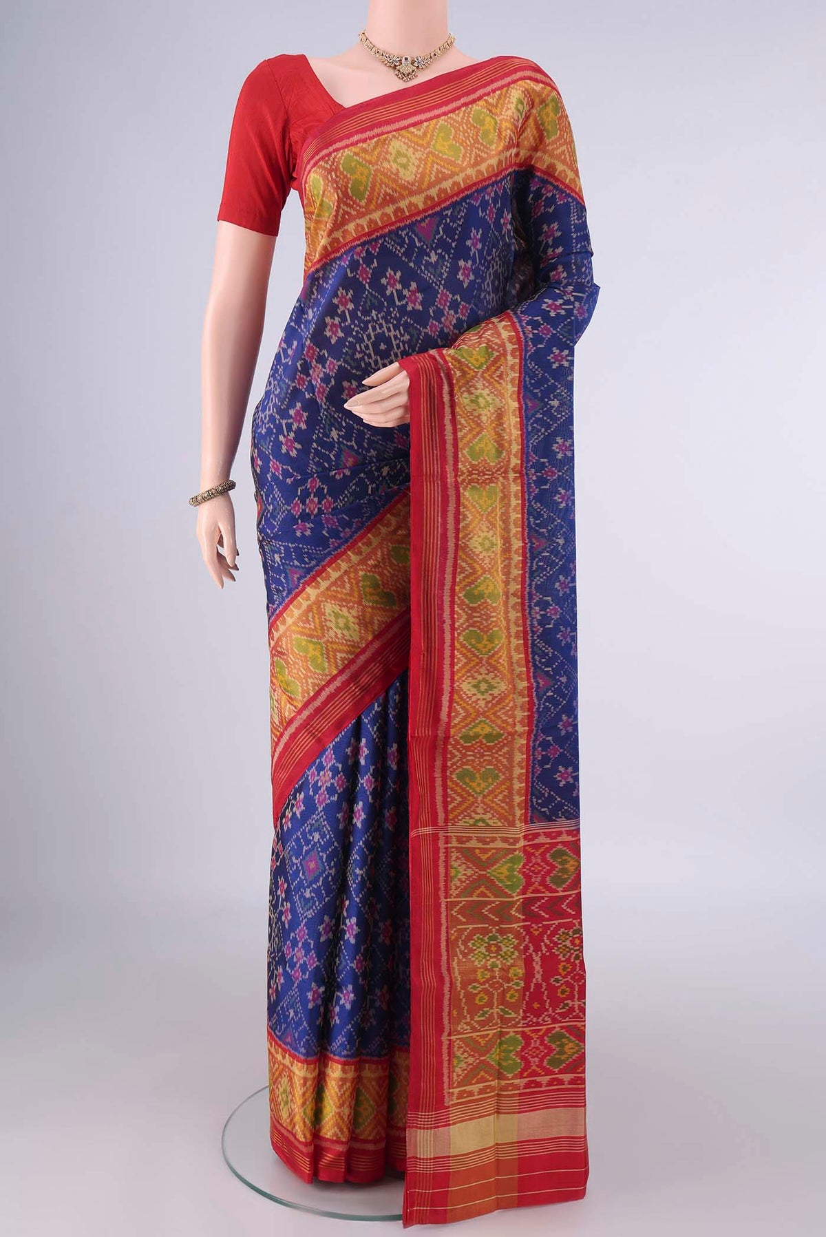 Pure Silk Dark Blue Rajkot Patola Saree with Pure Ikat on the body and Ikat Border.  displayed on a mannequin
