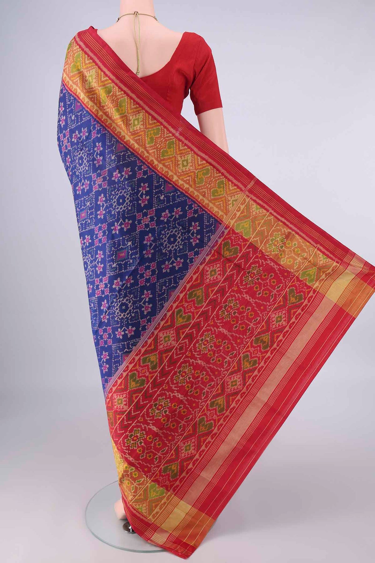Flat view of Pure Silk Dark Blue Rajkot Patola Saree with Pure Ikat on the body and Ikat Border. 