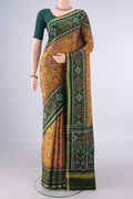 Pure Silk Mustard Rajkot Patola Saree with Pure Ikat on the body and Ikat Border.  displayed on a mannequin