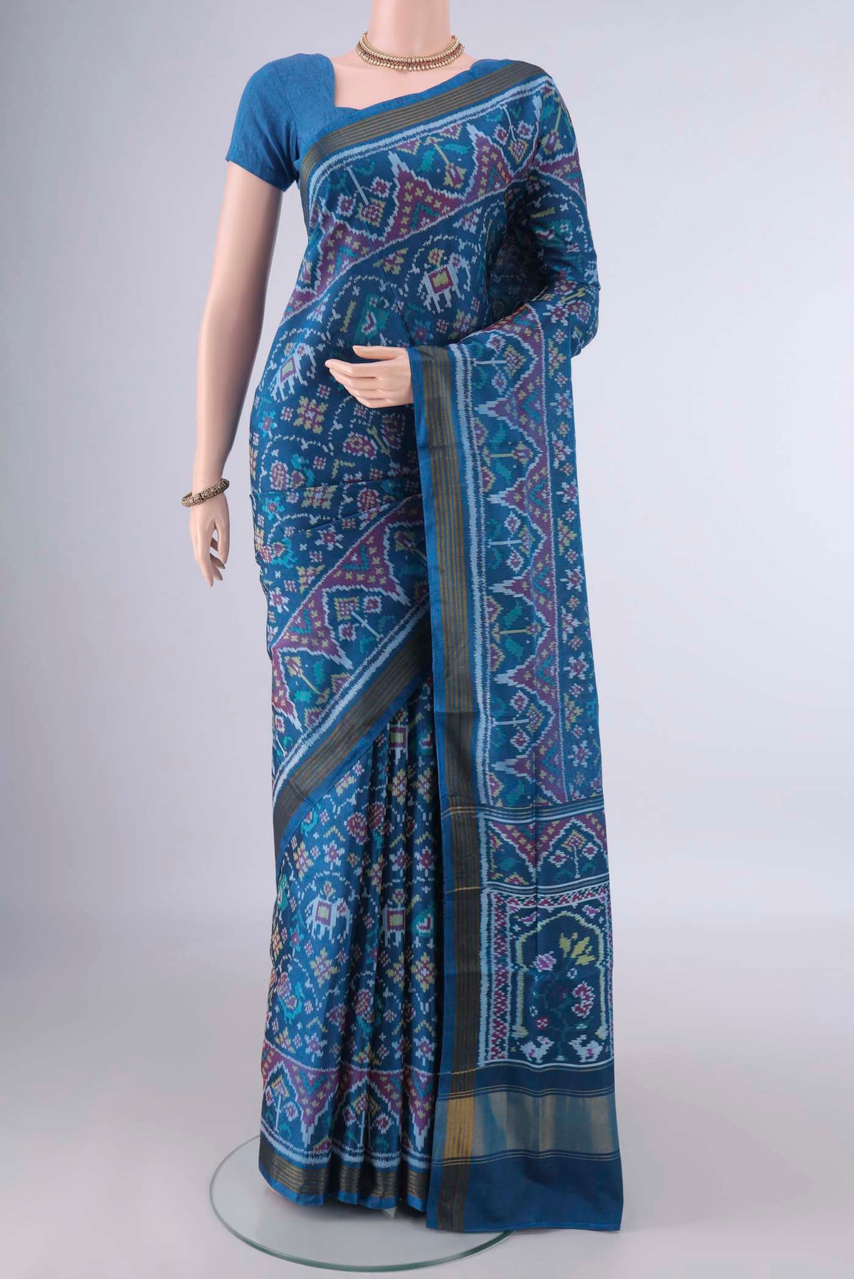 Pure Silk Blue Rajkot Patola Saree with Pure Ikat on the body and Ikat Border.  displayed on a mannequin