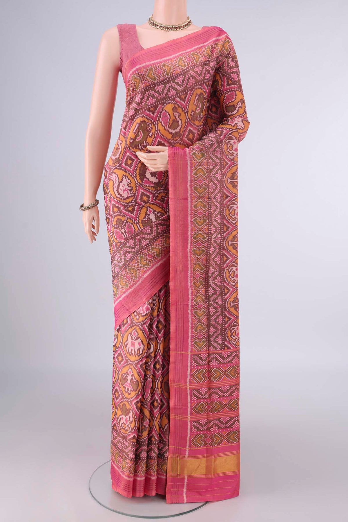 Pure Silk Rose pink Rajkot Patola Saree with Pure Ikat on the body and Ikat Border.  displayed on a mannequin