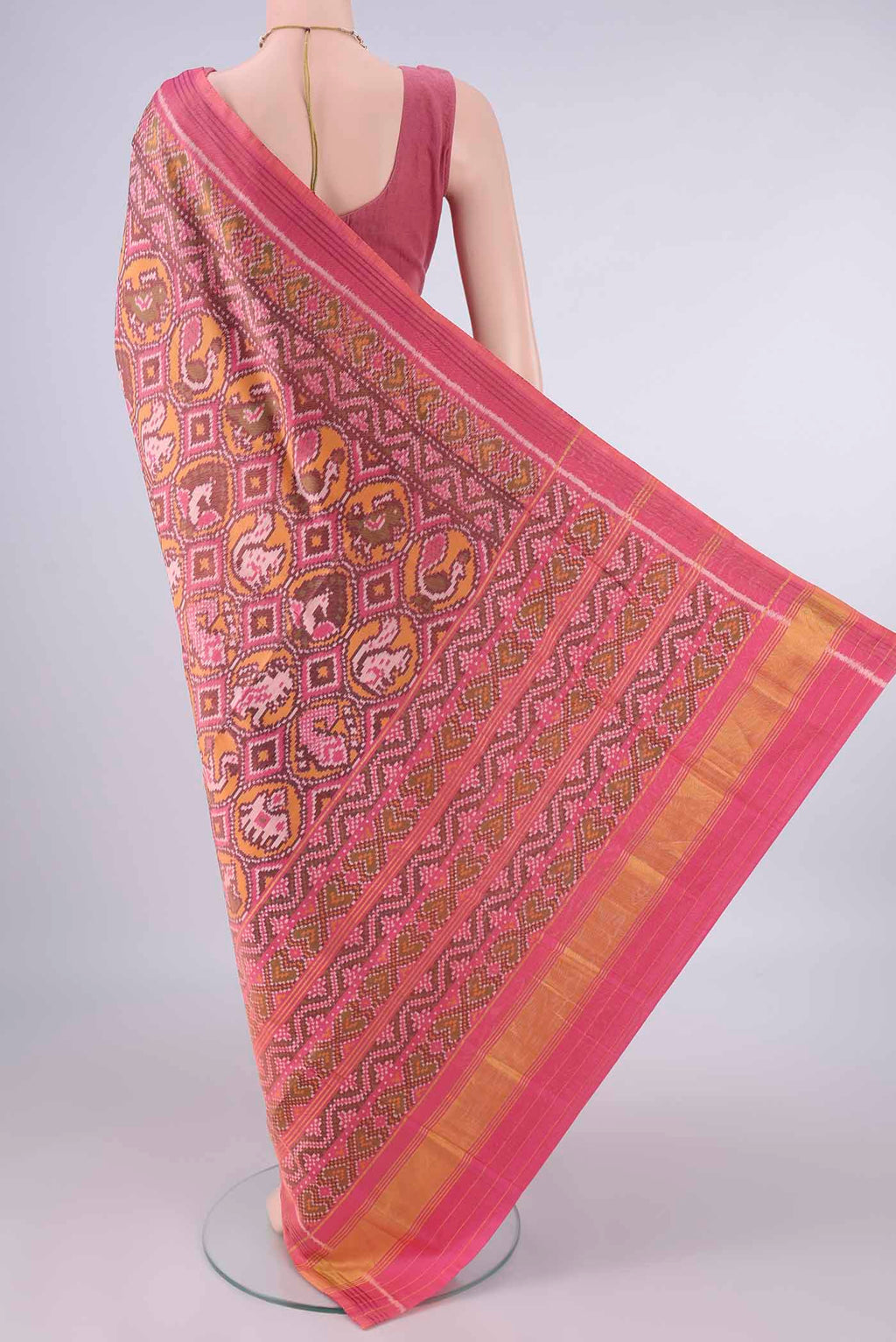 Flat view of Pure Silk Rose pink Rajkot Patola Saree with Pure Ikat on the body and Ikat Border. 
