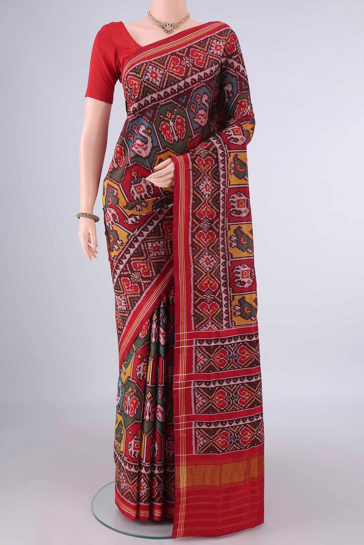 Pure Silk Coffee Brown Rajkot Patola Saree with Pure Ikat on the body and Ikat Border.  displayed on a mannequin