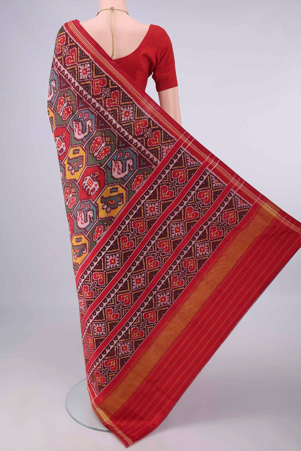 Flat view of Pure Silk Coffee Brown Rajkot Patola Saree with Pure Ikat on the body and Ikat Border. 
