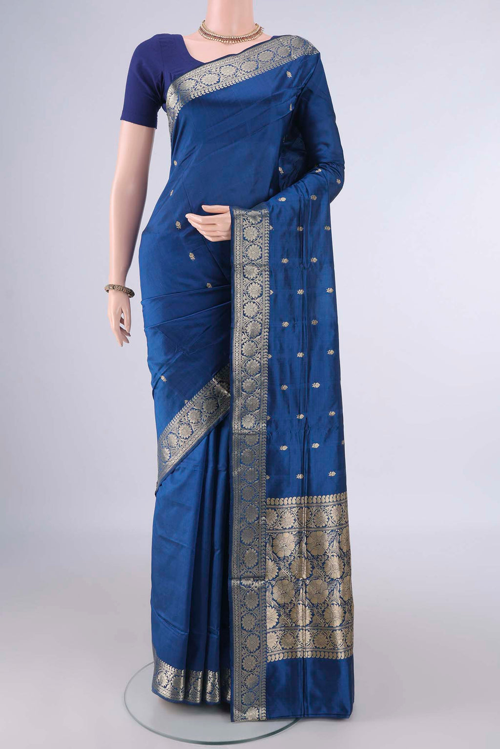Pure Silk Peacock Blue Dual Tone Banarasi Katan Saree with Zari Butta on the body and Zari Border.  displayed on a mannequin