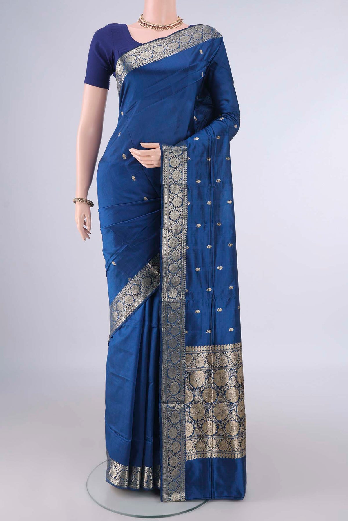 Pure Silk Peacock Blue Dual Tone Banarasi Katan Saree with Zari Butta on the body and Zari Border.  displayed on a mannequin