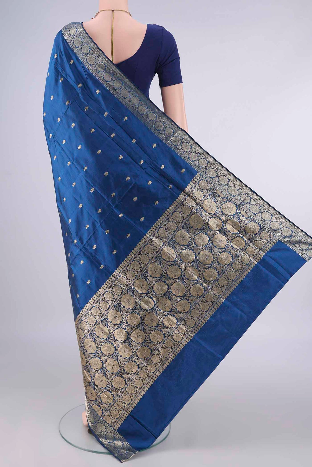 Flat view of Pure Silk Peacock Blue Dual Tone Banarasi Katan Saree with Zari Butta on the body and Zari Border. 