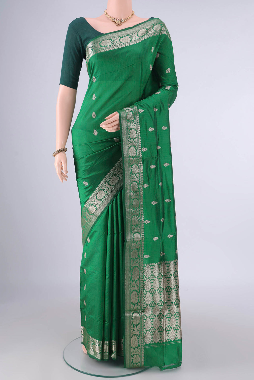 Pure Silk Green Banarasi Katan Saree with Zari Butta on the body and Zari Border.  displayed on a mannequin