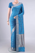 Pure Silk Sky Blue Banarasi Katan Saree with Zari Butta on the body and Zari Border.  displayed on a mannequin