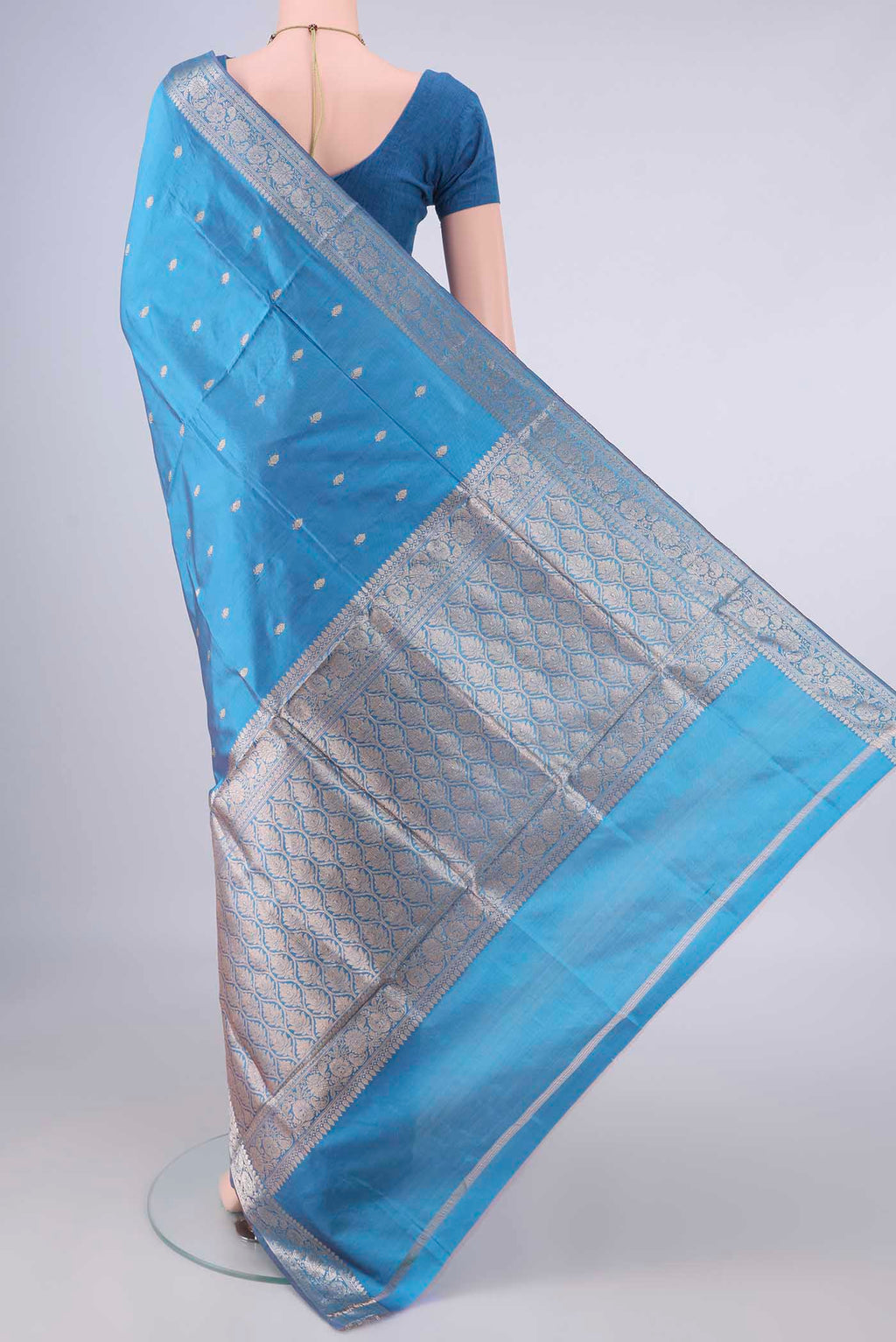 Flat view of Pure Silk Sky Blue Banarasi Katan Saree with Zari Butta on the body and Zari Border. 