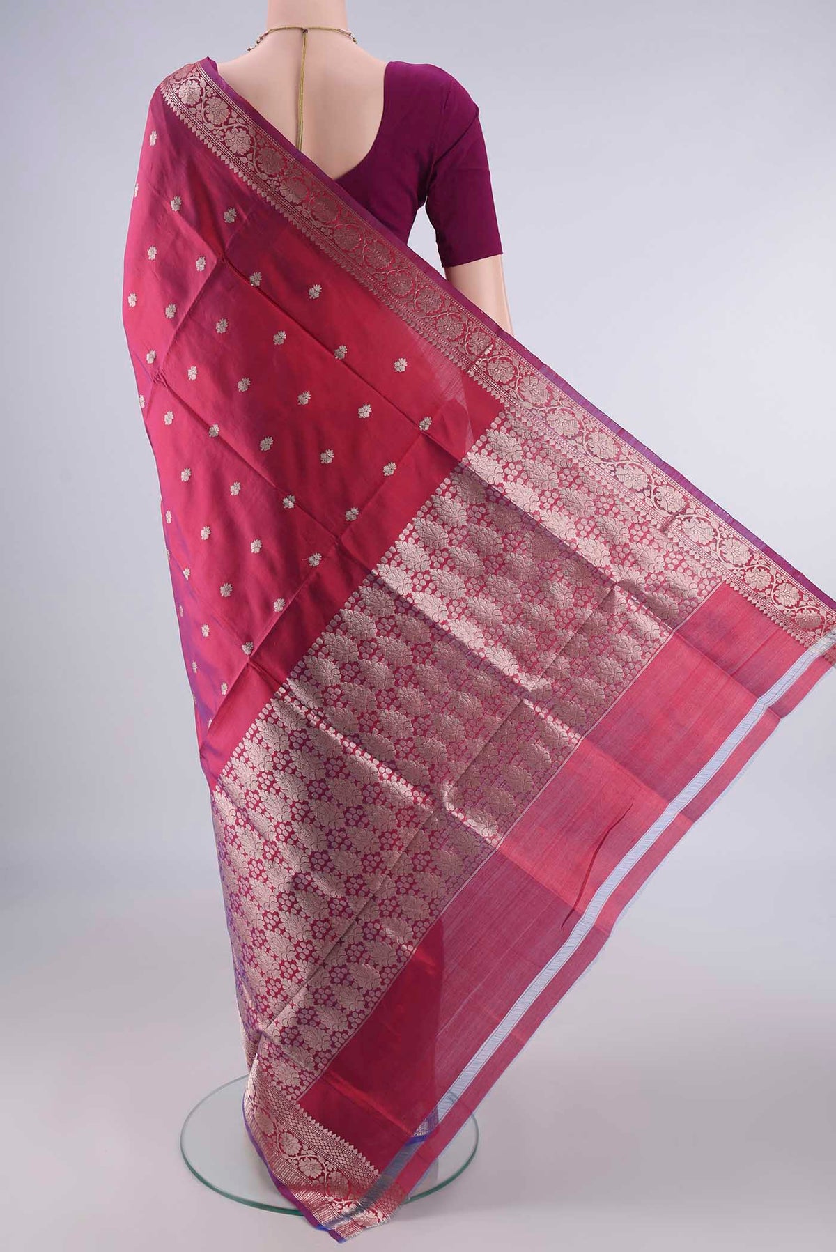 Flat view of Pure Silk Maroon Dual Tone Banarasi Katan Saree with Zari Butta on the body and Zari Border. 