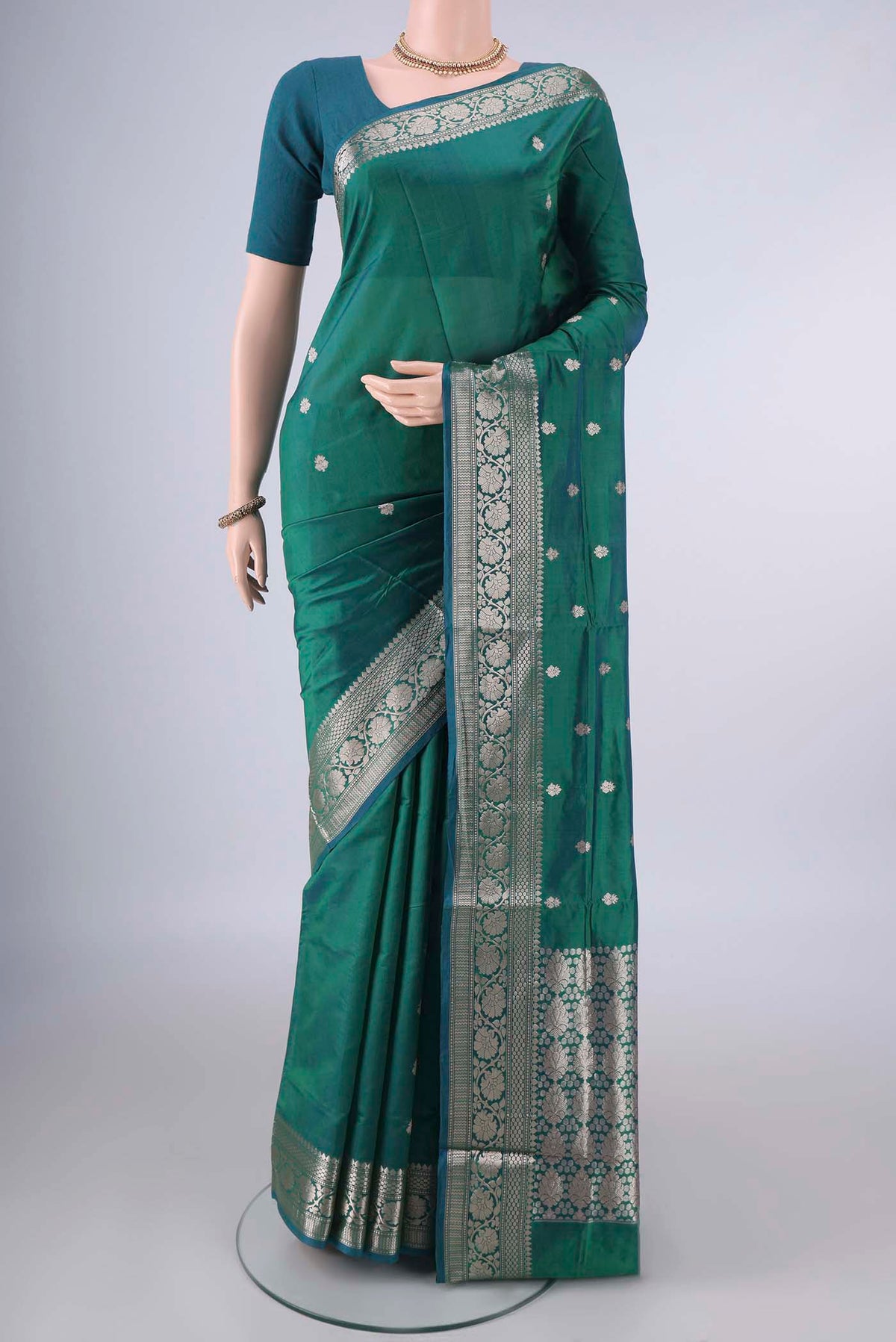 Pure Silk Green Dual Tone Banarasi Katan Saree with Zari Butta on the body and Zari Border.  displayed on a mannequin