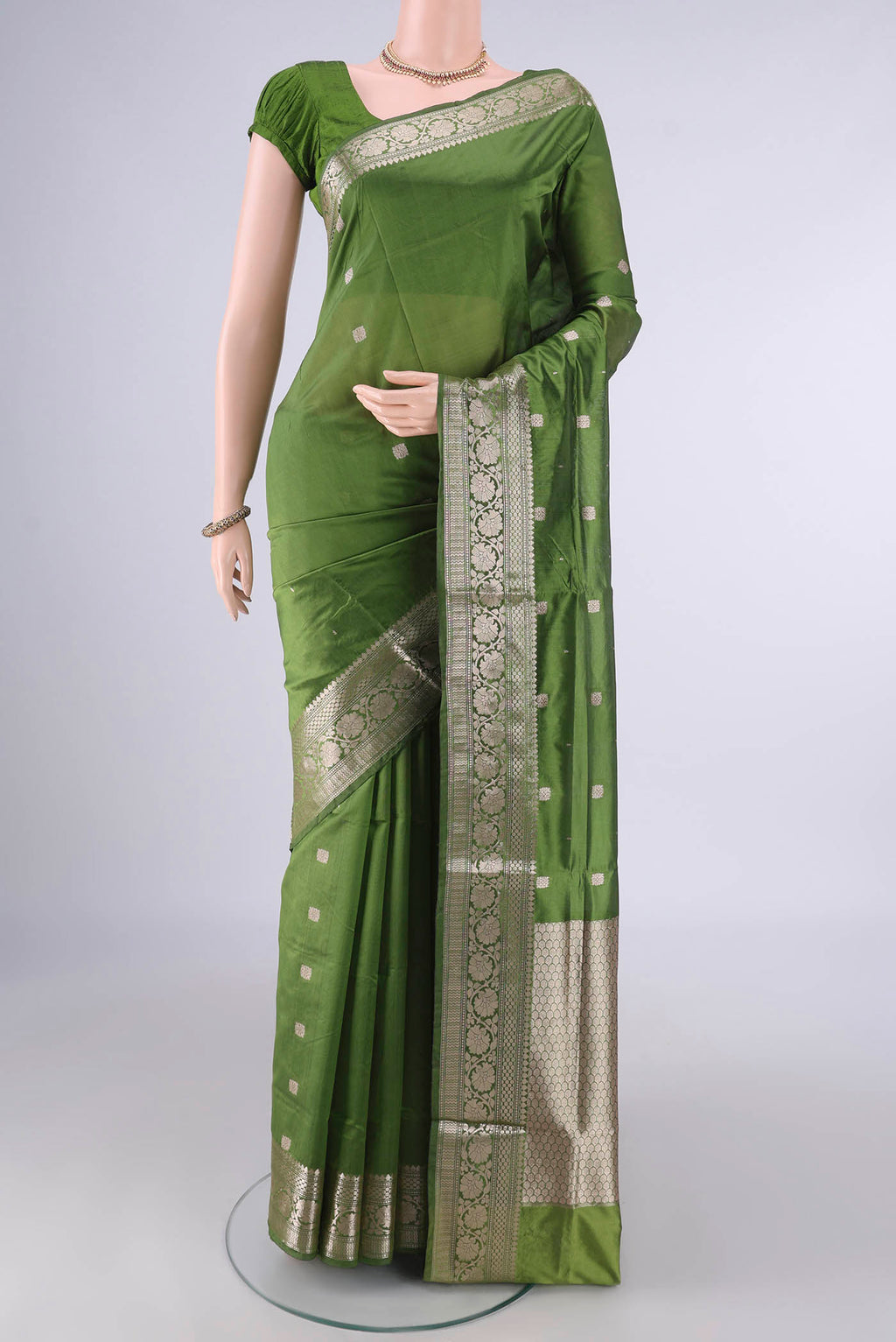 Pure Silk Mehandi Green Banarasi Katan Saree with Zari Butta on the body and Zari Border.  displayed on a mannequin