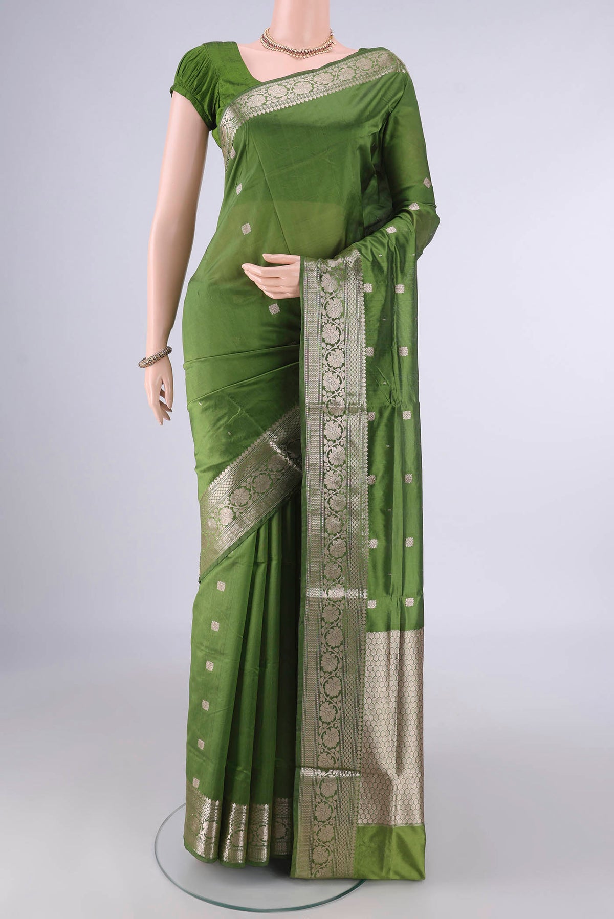 Pure Silk Mehandi Green Banarasi Katan Saree with Zari Butta on the body and Zari Border.  displayed on a mannequin