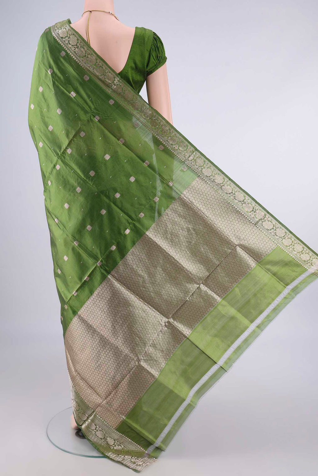 Flat view of Pure Silk Mehandi Green Banarasi Katan Saree with Zari Butta on the body and Zari Border. 