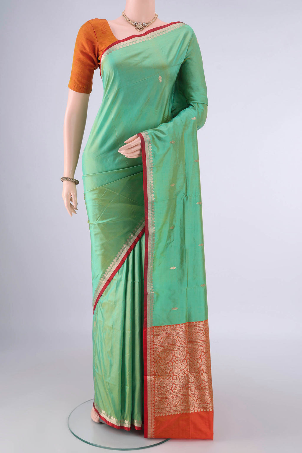 Pure Silk Light Green Banarasi Katan Saree with Zari Butta on the body and Zari Border.  displayed on a mannequin