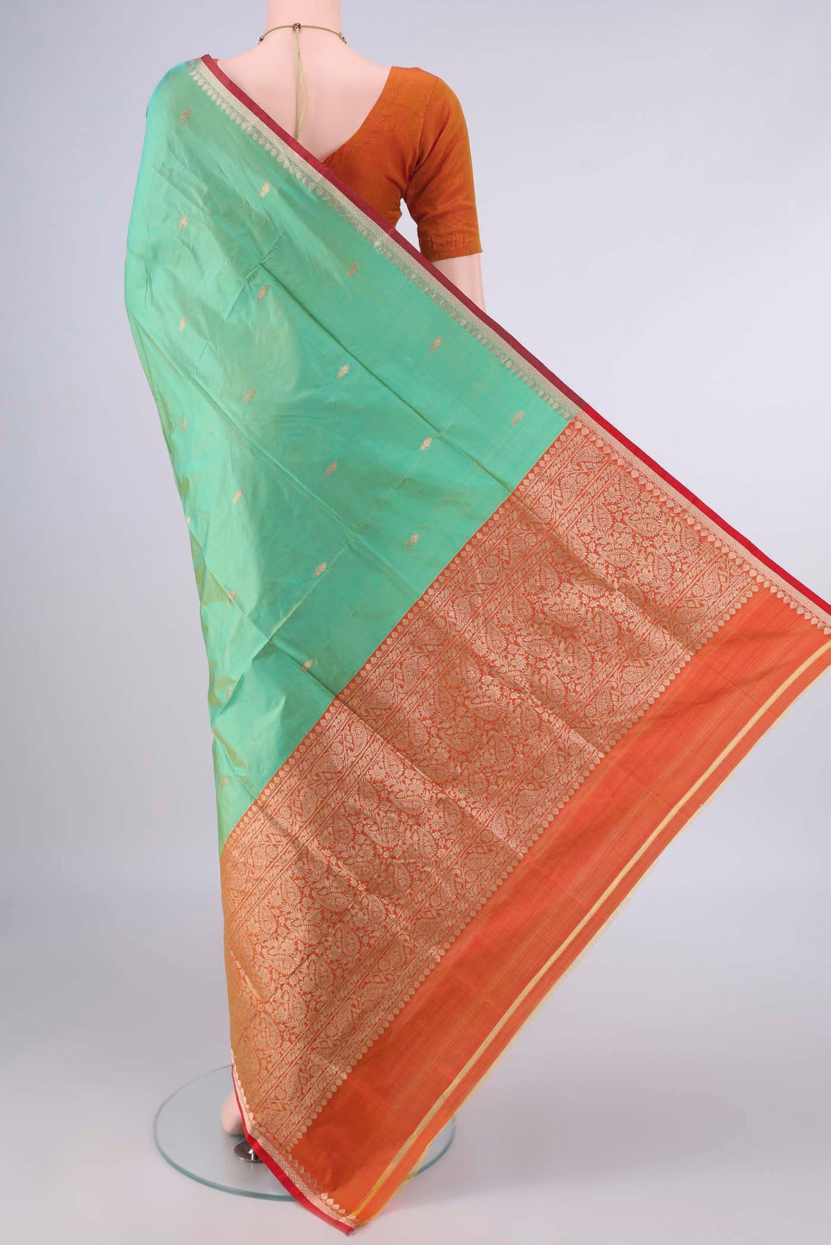 Flat view of Pure Silk Light Green Banarasi Katan Saree with Zari Butta on the body and Zari Border. 