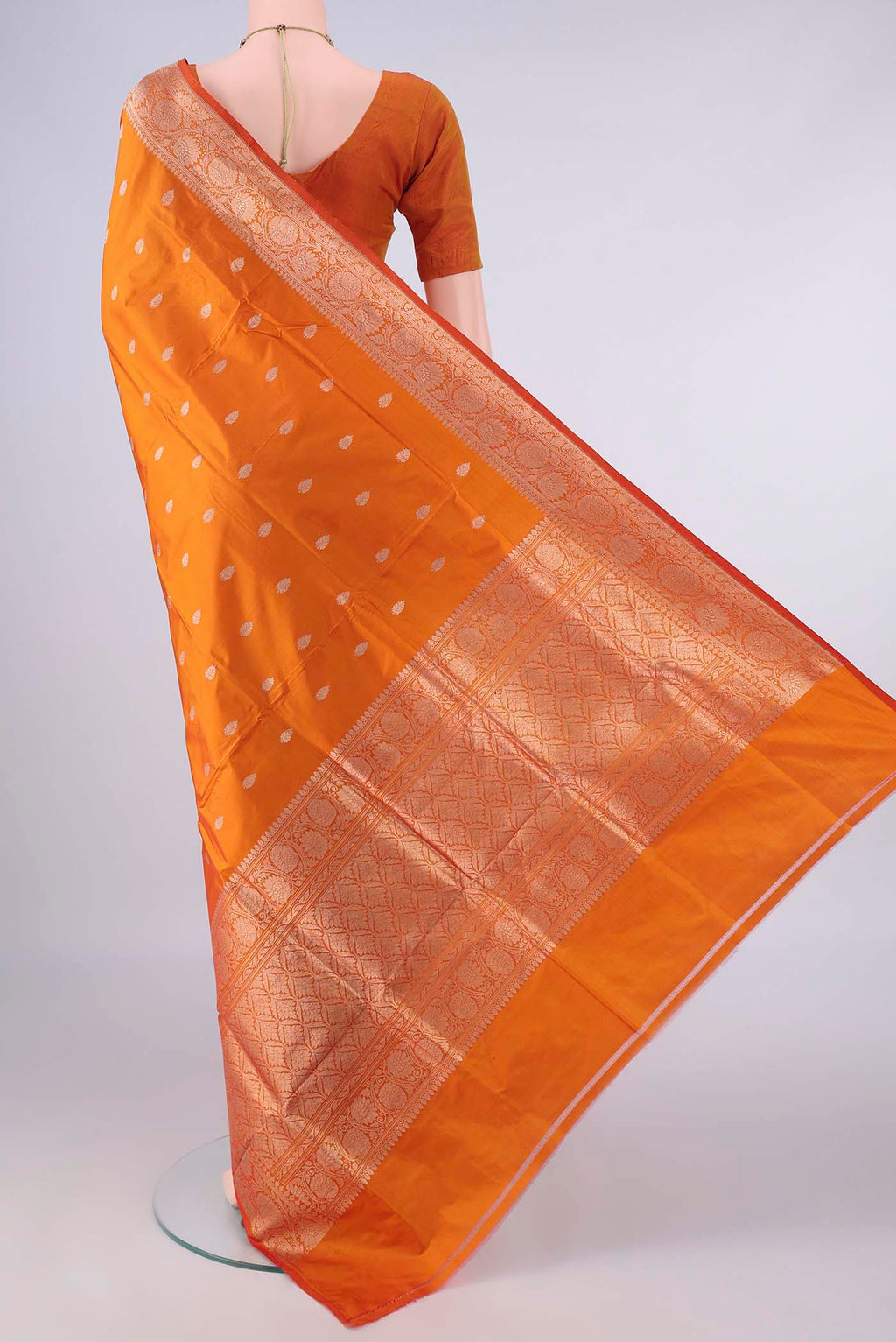 Flat view of Pure Silk Orange Banarasi Katan Saree with Zari Butta on the body and Zari Border. 