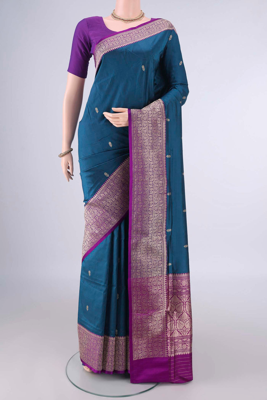 Pure Silk Peacock Blue Banarasi Katan Saree with Zari Butta on the body and Zari Border.  displayed on a mannequin