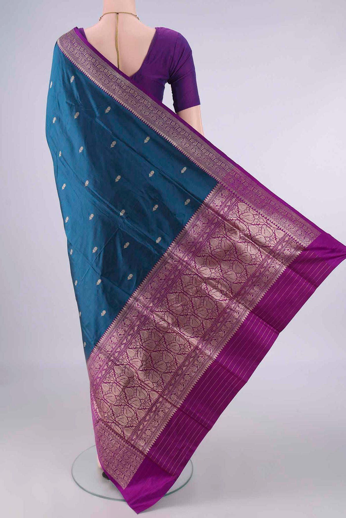 Flat view of Pure Silk Peacock Blue Banarasi Katan Saree with Zari Butta on the body and Zari Border. 