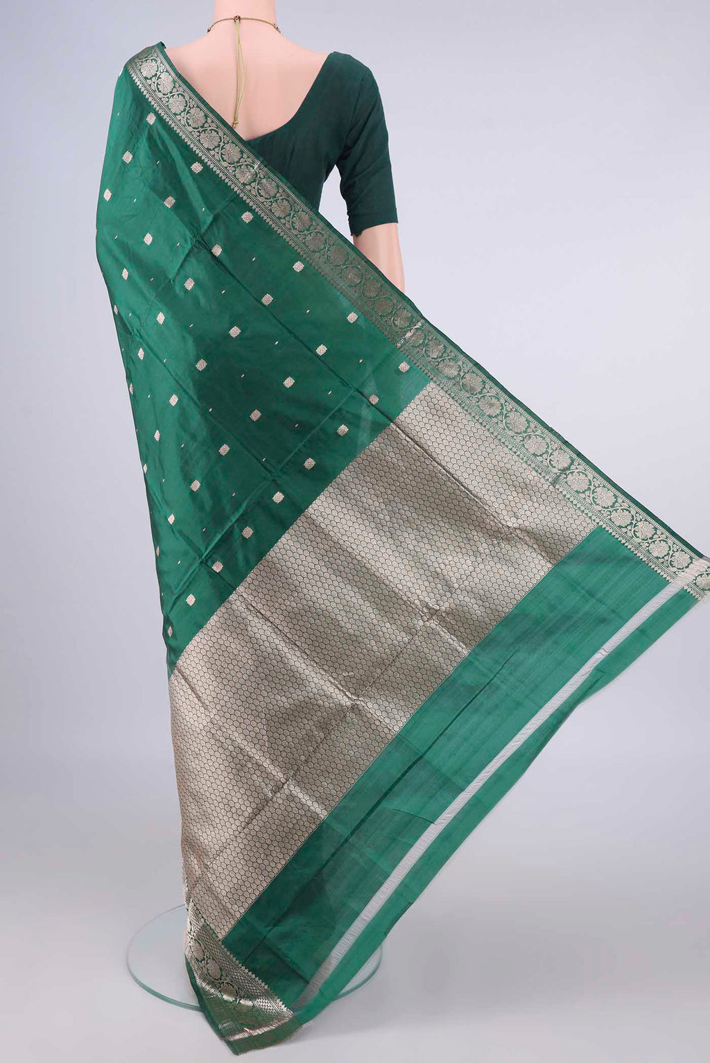 Flat view of Pure Silk Bottle Green Banarasi Katan Saree with Zari Butta on the body and Zari Border. 