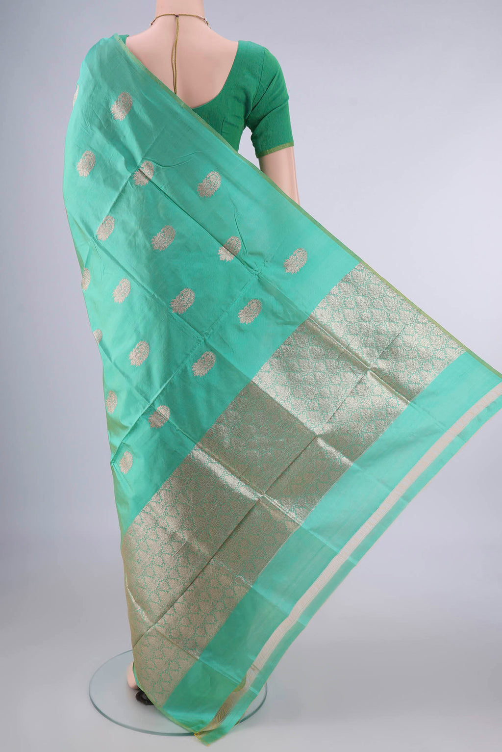 Flat view of Pure Silk Green Banarasi Katan Saree with Zari Butta on the body and Without Border. 