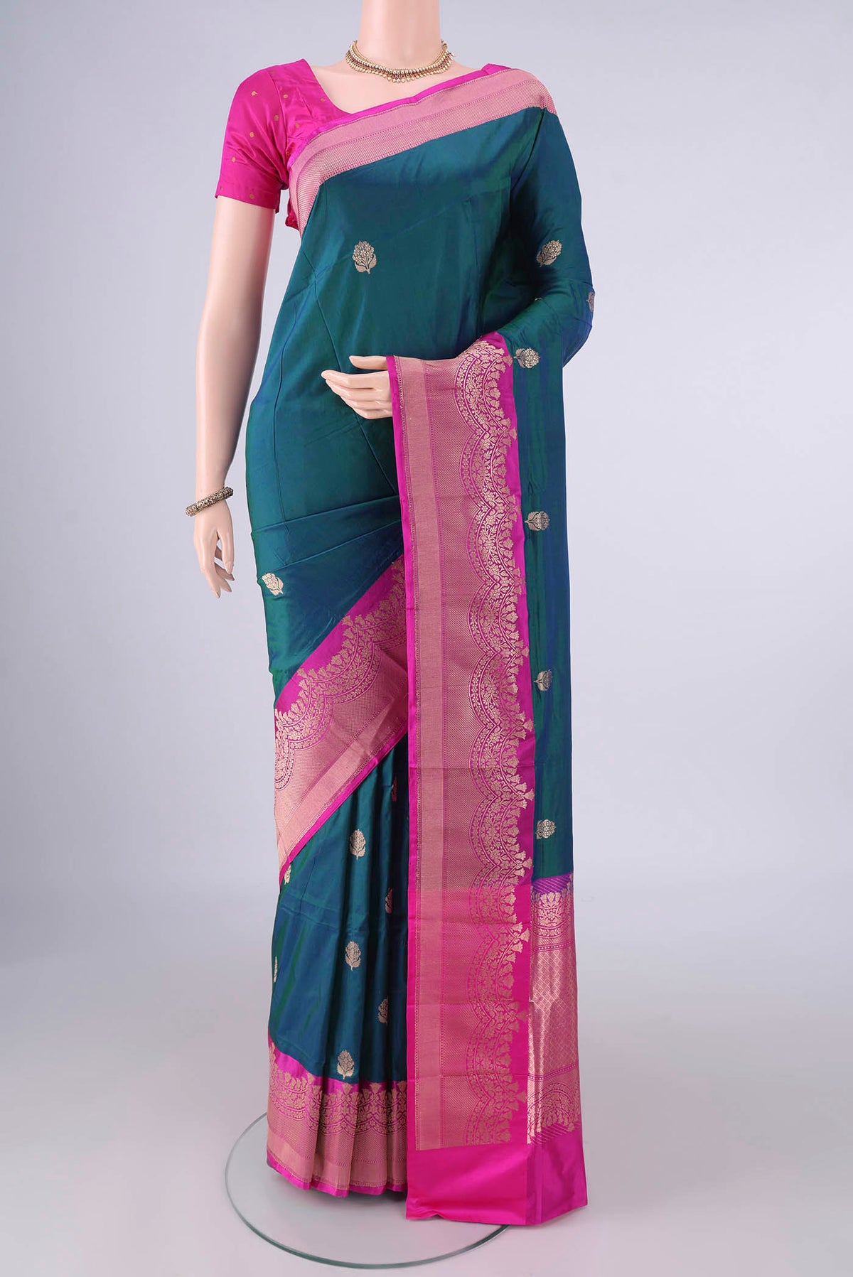 Pure Silk Peacock Blue Banarasi Katan Saree with Zari Butta on the body and Zari Border.  displayed on a mannequin