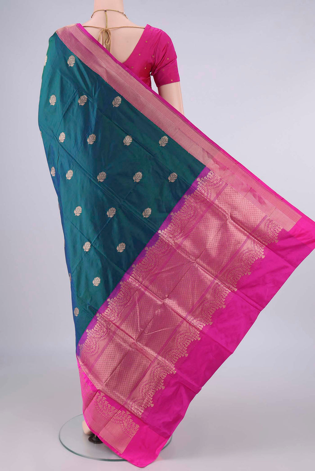 Flat view of Pure Silk Peacock Blue Banarasi Katan Saree with Zari Butta on the body and Zari Border. 