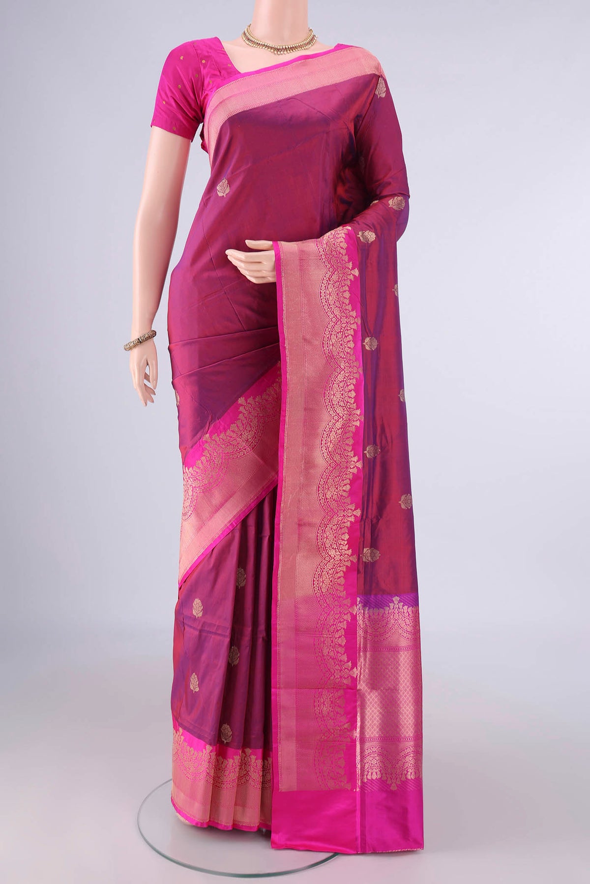 Pure Silk Magenta Dual Tone Banarasi Katan Saree with Zari Butta on the body and Zari Border.  displayed on a mannequin