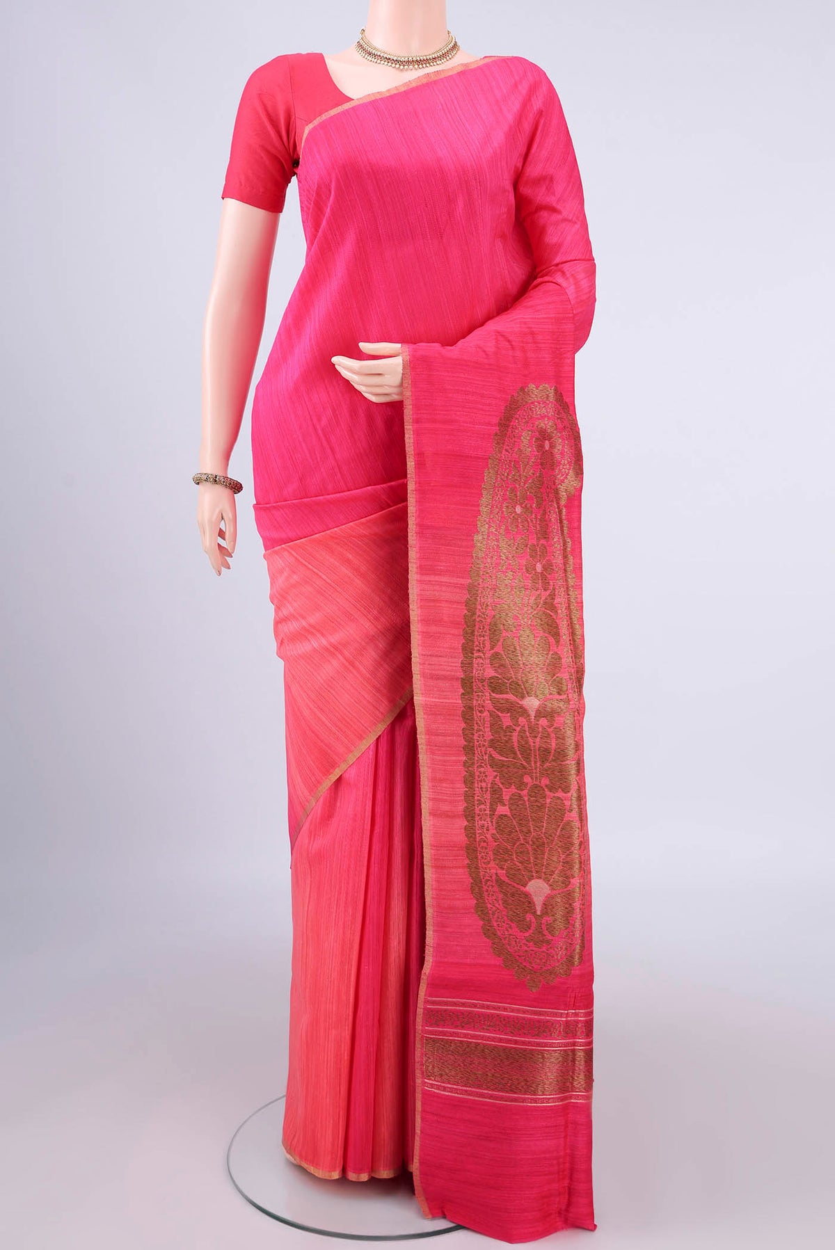 Pure Silk Pink and Coral Color Jute Saree with Zari Butta on the body and Zari Border.  displayed on a mannequin