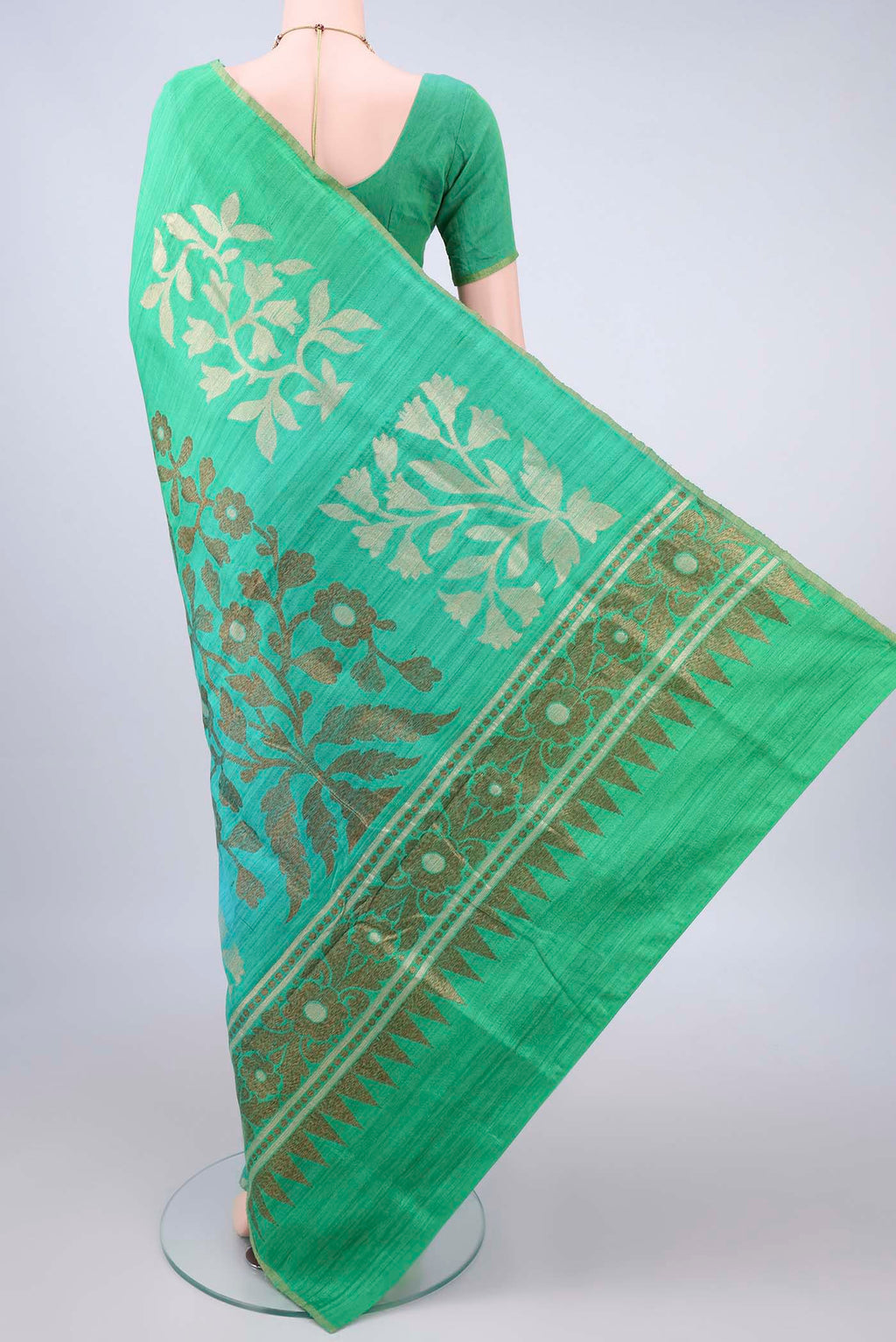 Flat view of Pure Silk Green and Light Blue Color Jute Saree with Ombre design on the body and Zari Border. 