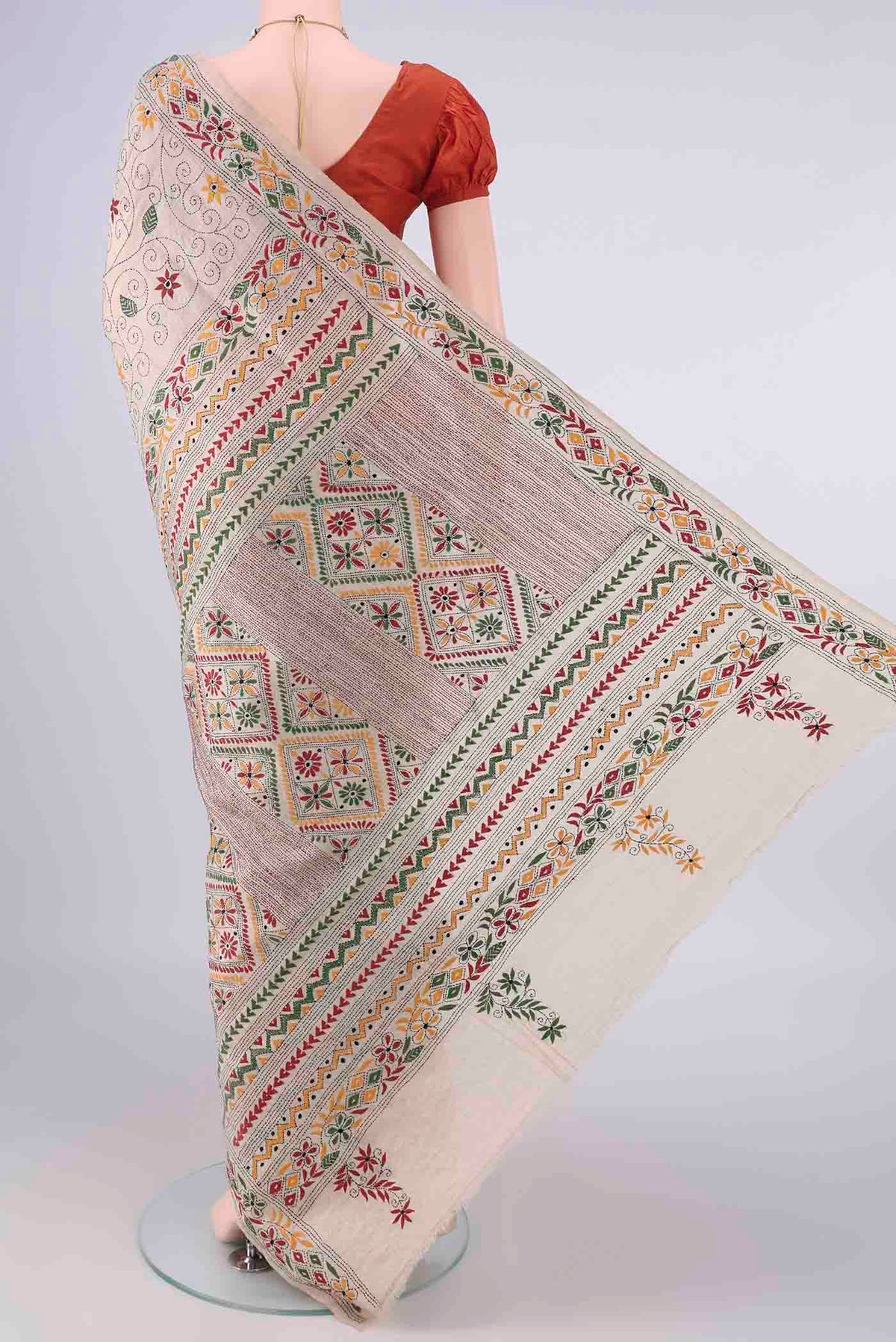 Flat view of Beige Tussar Saree with Kantha Work on the body and Thread Border. 