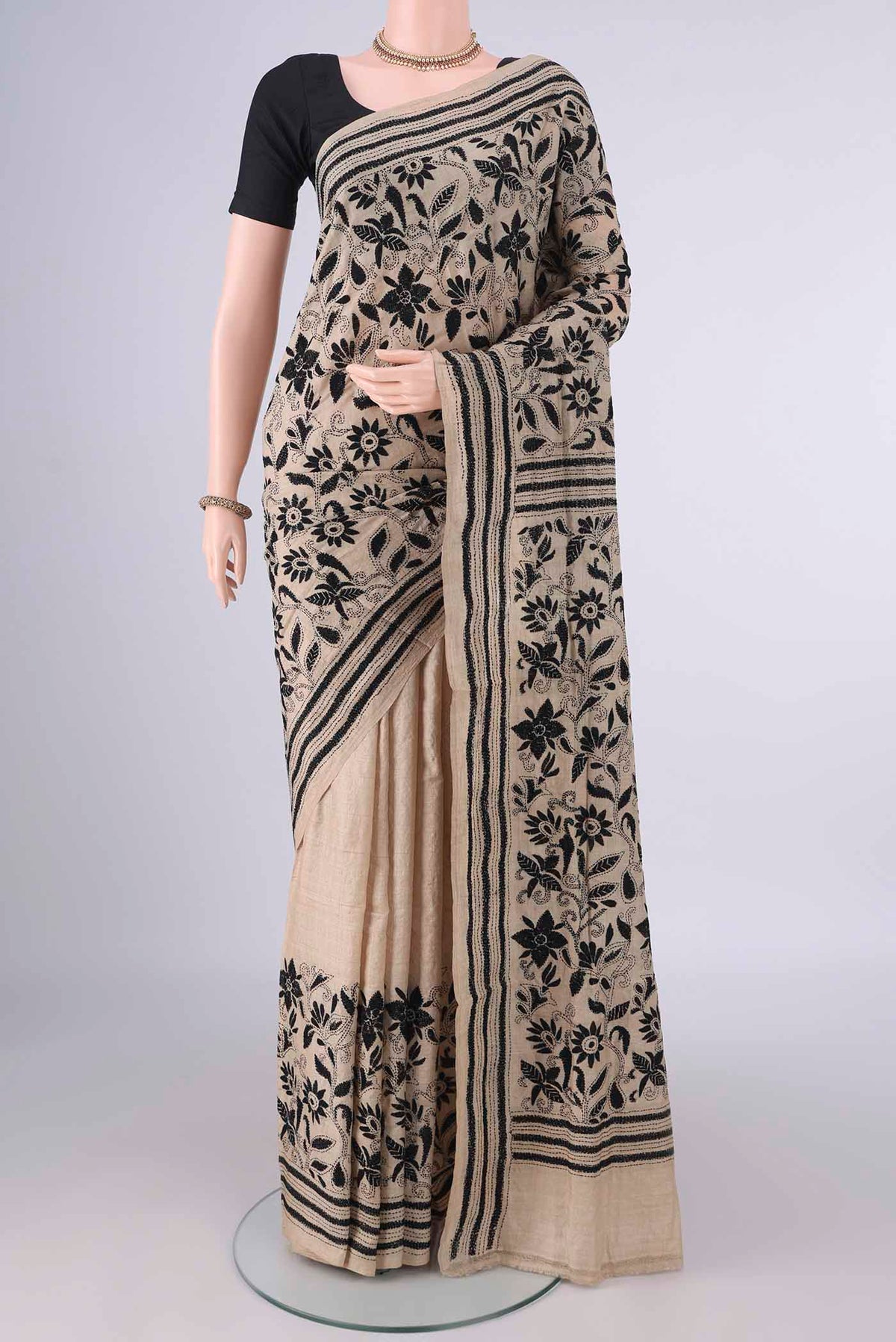 Beige Tussar Saree with Kantha Work on the body and Thread Border.  displayed on a mannequin