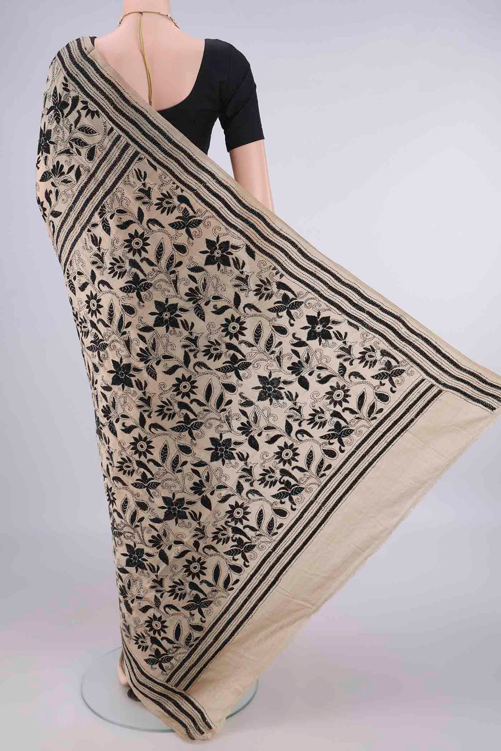 Flat view of Beige Tussar Saree with Kantha Work on the body and Thread Border. 
