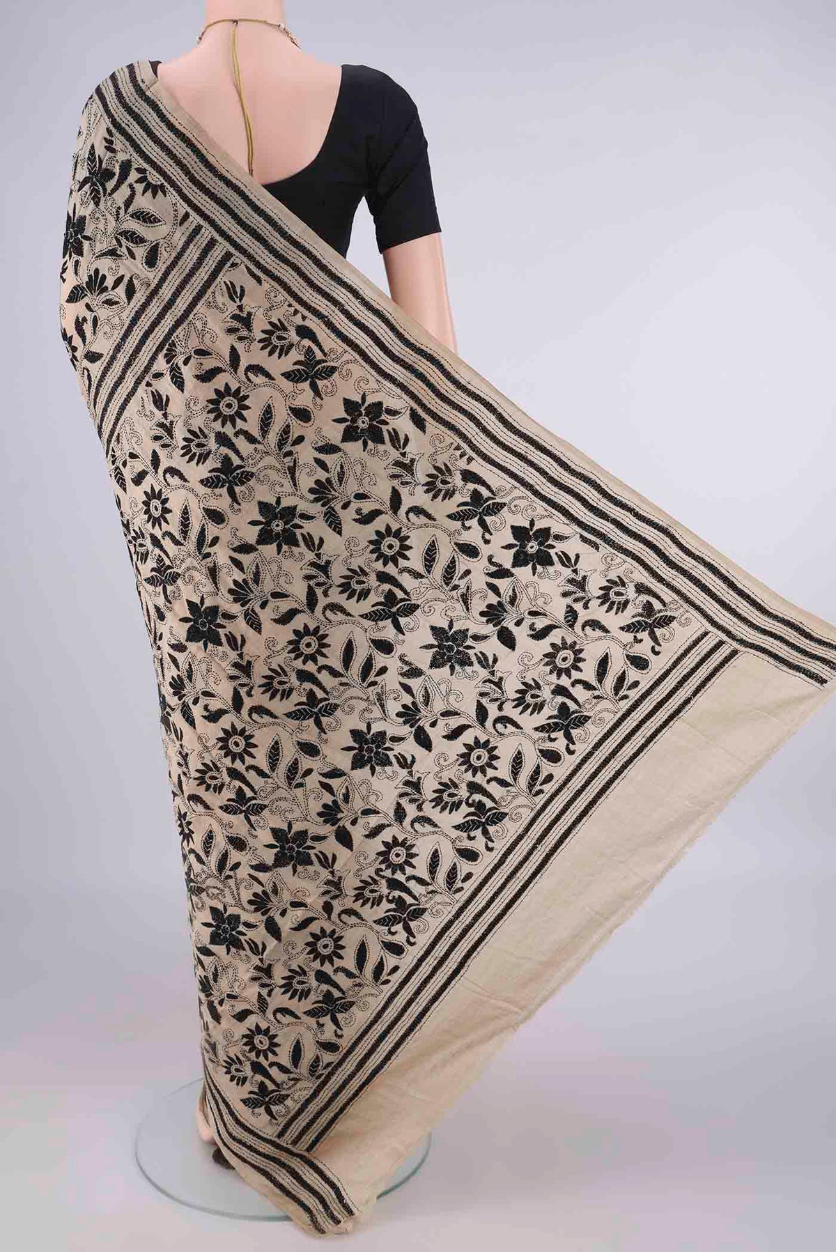 Flat view of Beige Tussar Saree with Kantha Work on the body and Thread Border. 