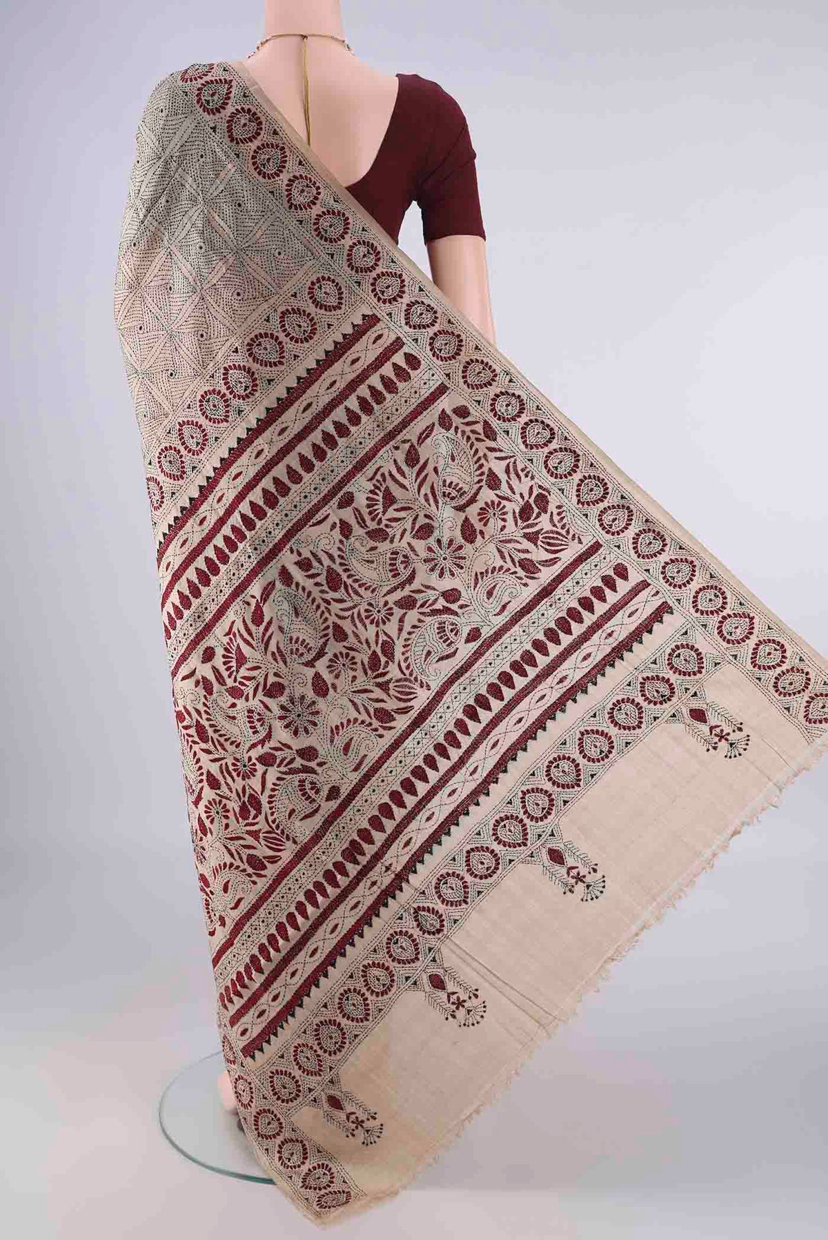Flat view of Beige Tussar Saree with Kantha Work on the body and Thread Border. 
