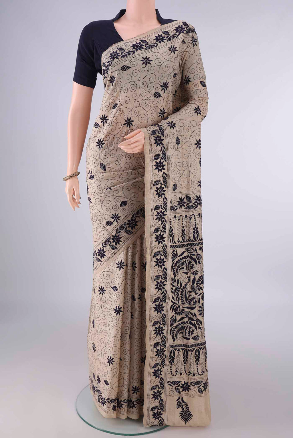 Beige Tussar Saree with Kantha Work on the body and Thread Border.  displayed on a mannequin