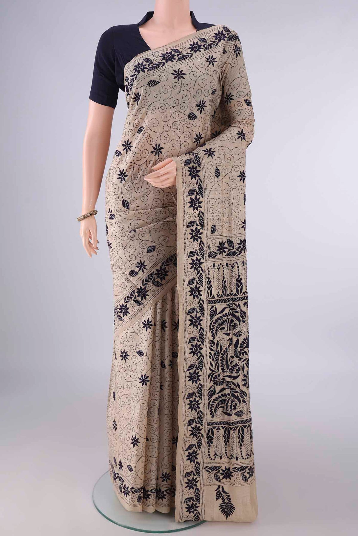 Beige Tussar Saree with Kantha Work on the body and Thread Border.  displayed on a mannequin