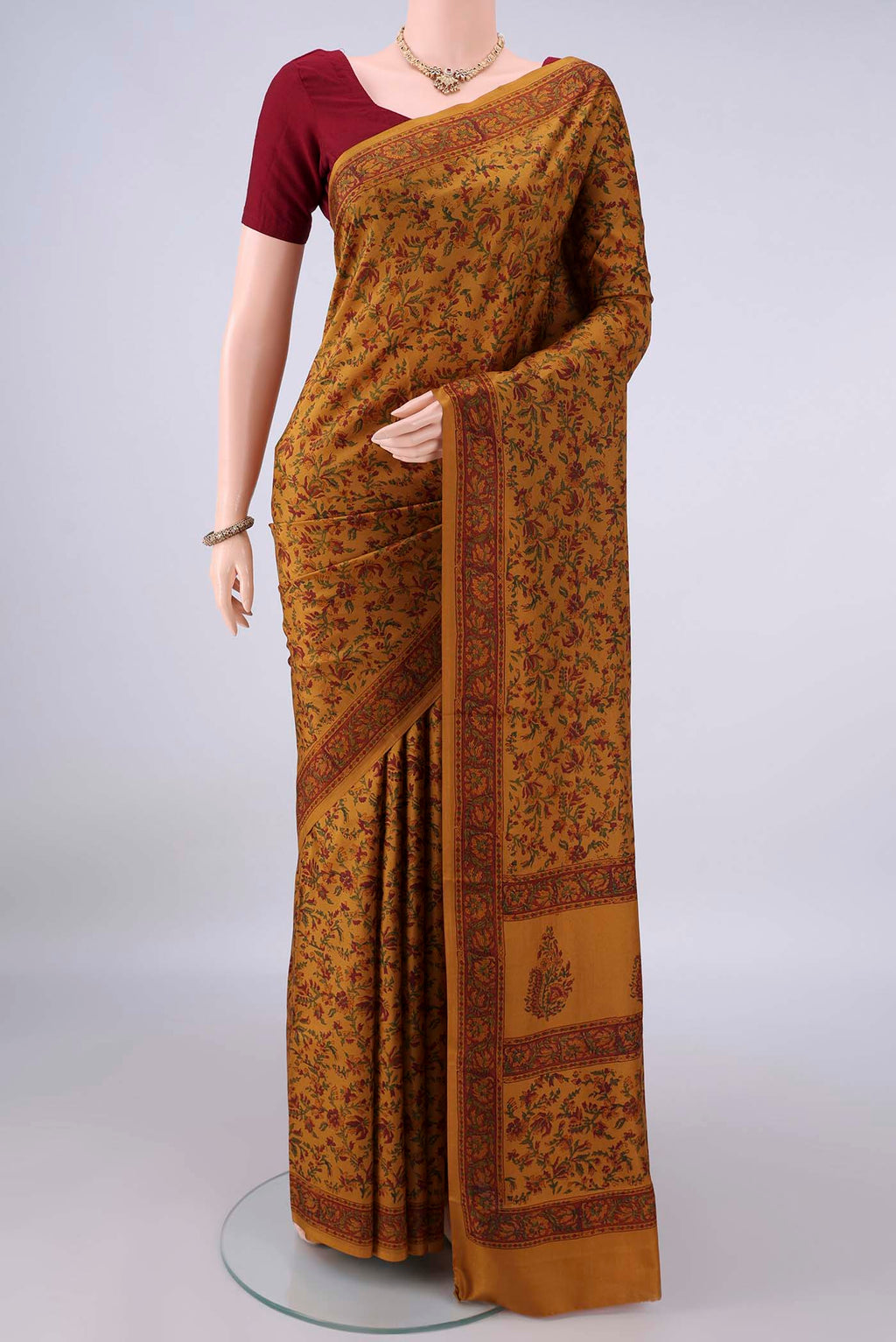 Pure Silk Mustard Printed Saree with Printed design on the body and Printed Border.  displayed on a mannequin