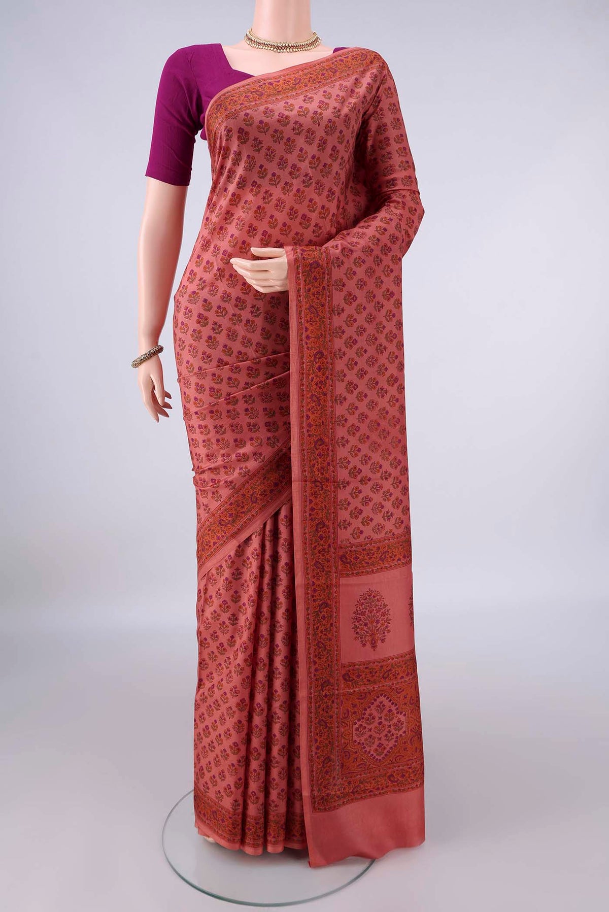 Pure Silk Coral Printed Saree with Printed design on the body and Printed Border.  displayed on a mannequin