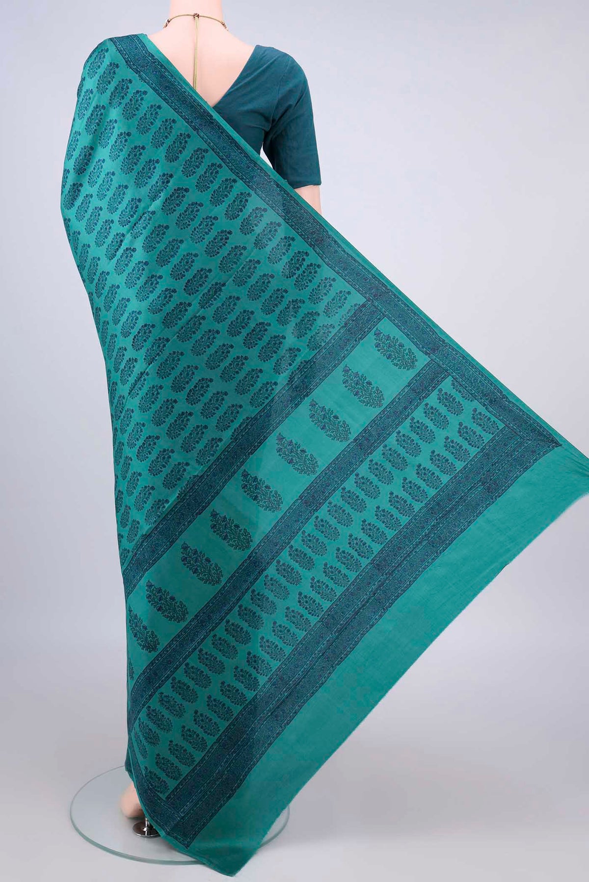 Flat view of Pure Silk Teal Printed Saree with Printed design on the body and Printed Border. 
